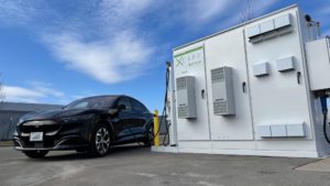 New, all-electric Ford Mustang Mach-E next to the EnTech Solutions Xcape microgrid