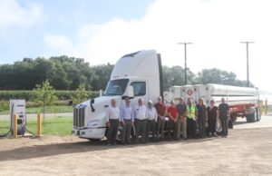 Representatives from Faith Technologies Incorporated, EnTech Solutions, Peterbilt/PACCAR, JX Enterprises, Maki Trucking and Dane County pose in front of the Peterbilt EV demo truck and EV charger at the Middleton Digester. (Photo courtesy EnTech Solutions)